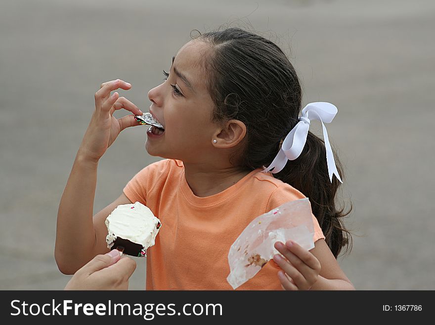 Little girl enjoying a vanilla ice cream bar. Little girl enjoying a vanilla ice cream bar