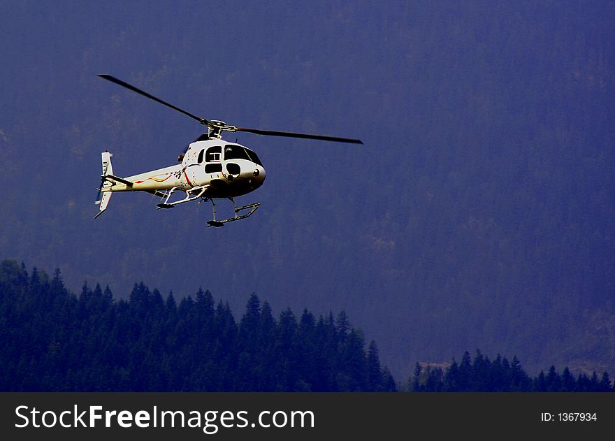 A helicopter approaching,mountain background. A helicopter approaching,mountain background