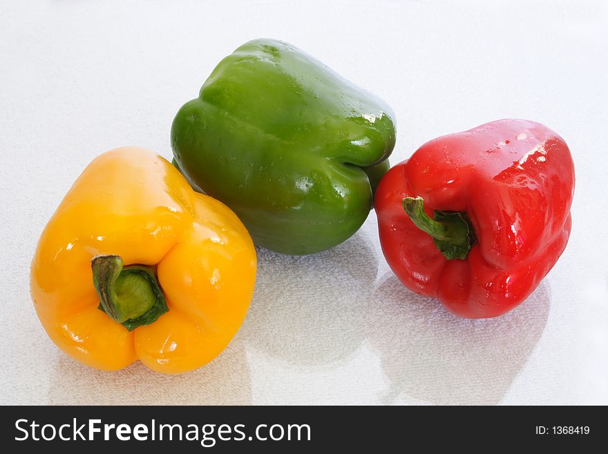 Three colorful peppers with  white background. Three colorful peppers with  white background