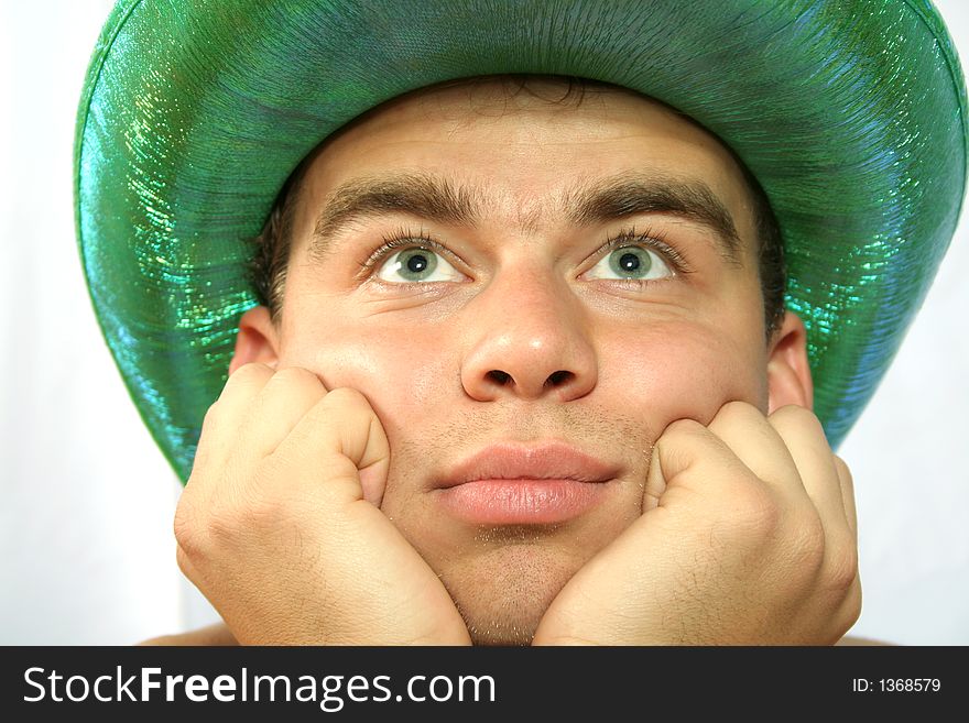 Man in green hat is looking up and dreaming. Man in green hat is looking up and dreaming
