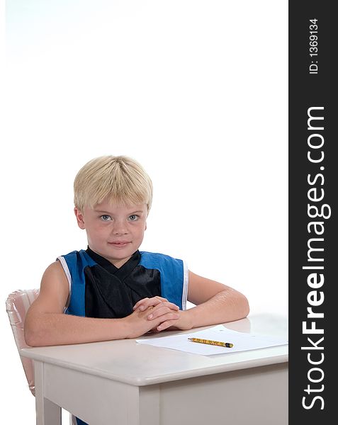 Young male student ready for assignment sitting at desk. Young male student ready for assignment sitting at desk