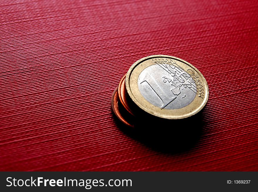 Euro coins on red surface. Euro coins on red surface
