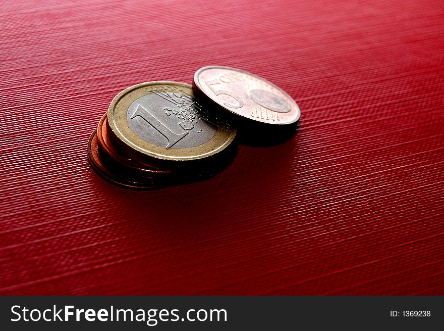 Euro coins on red surface. Euro coins on red surface