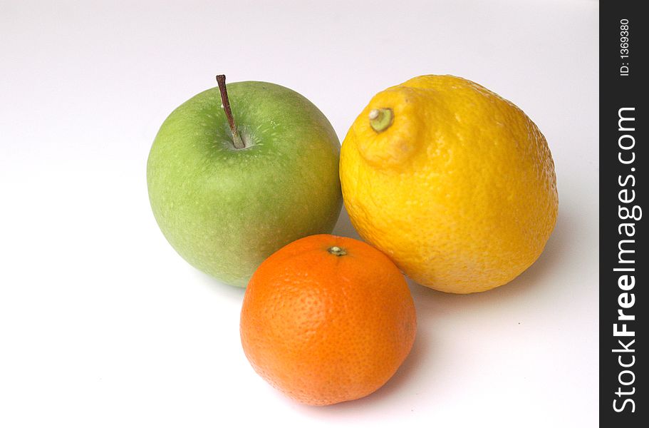 Colorful citrus fruits yellow lemon, green apple and orange tangerine.