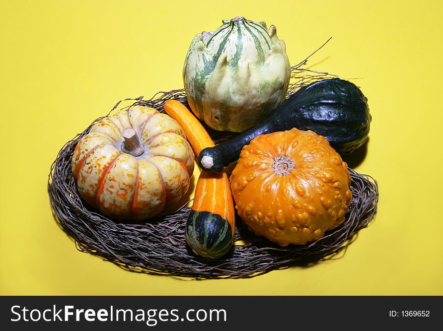 Some gourds arranged with willow branches on a yellow background. Some gourds arranged with willow branches on a yellow background.
