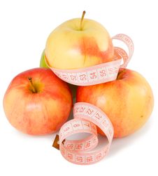 Pink Measuring Tape And Some Apples Royalty Free Stock Photos