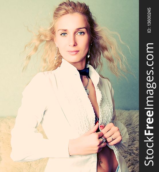 Portrait of a blond girl in white blouse