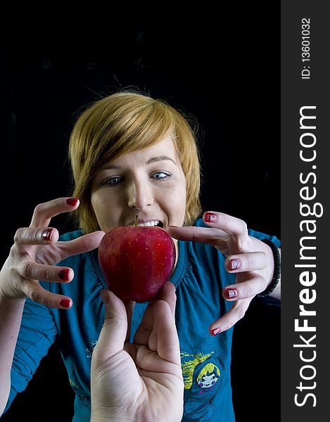 Cute young blond girl and her red apple. Cute young blond girl and her red apple