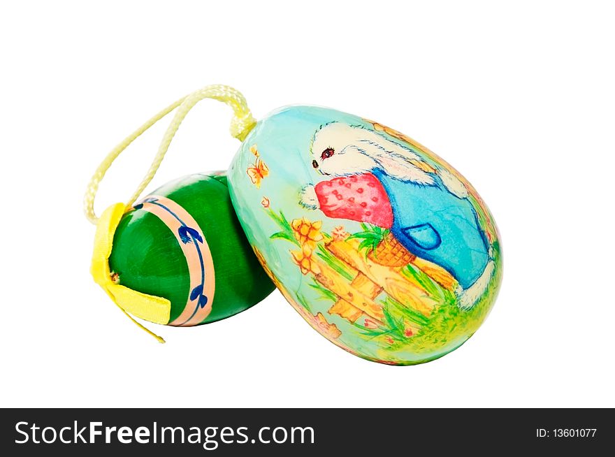 Two colorfully decorated Easter eggs on a white background.  One has a rabbit at a garden fence. Two colorfully decorated Easter eggs on a white background.  One has a rabbit at a garden fence.