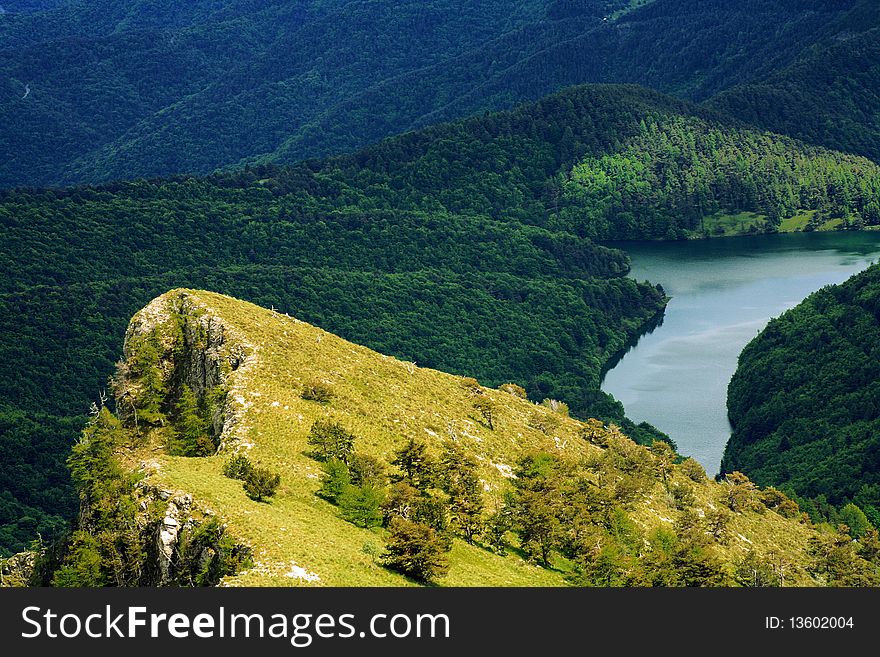 A panoramic view of lake gray and the mountains in italian Apennines. A panoramic view of lake gray and the mountains in italian Apennines