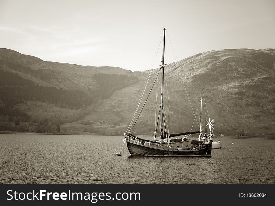 A wooden boat on one of Scottish lakes, Highlands, UK. A wooden boat on one of Scottish lakes, Highlands, UK.