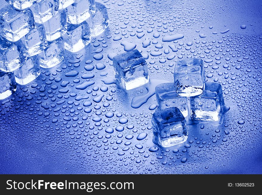 Ice cubes closeup on blue background with bubbles