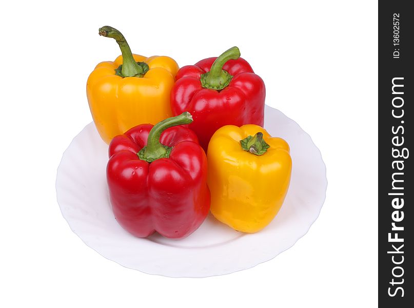 Multi-coloured pepper on a plate. Isolated object.