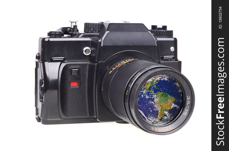 Old SLR camera. In a lens the globe is reflected