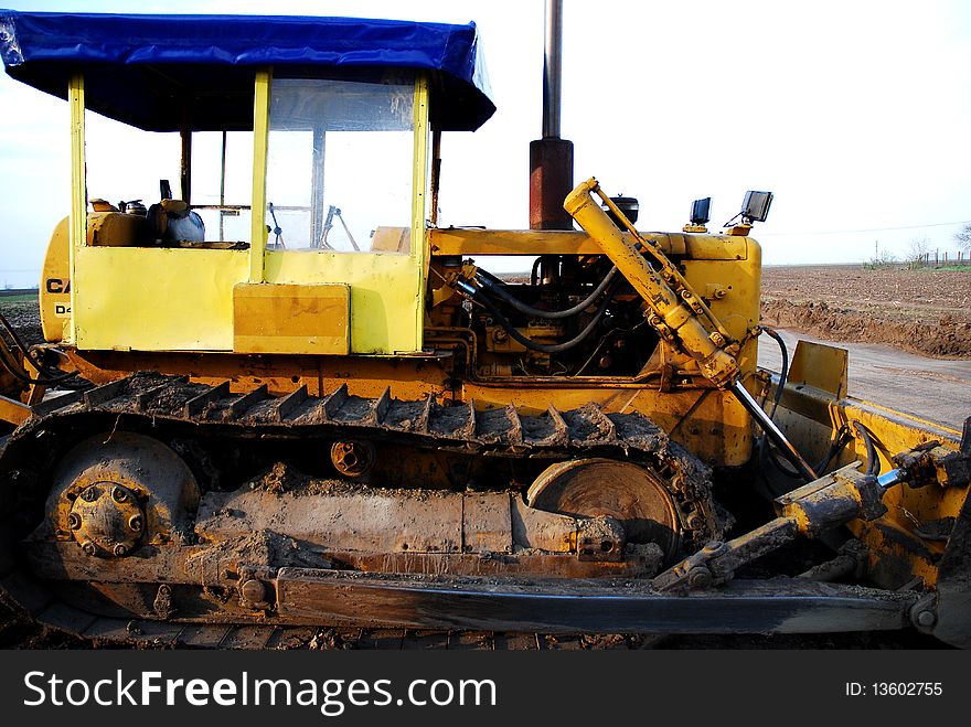 Aged yellow construction machinery,romania