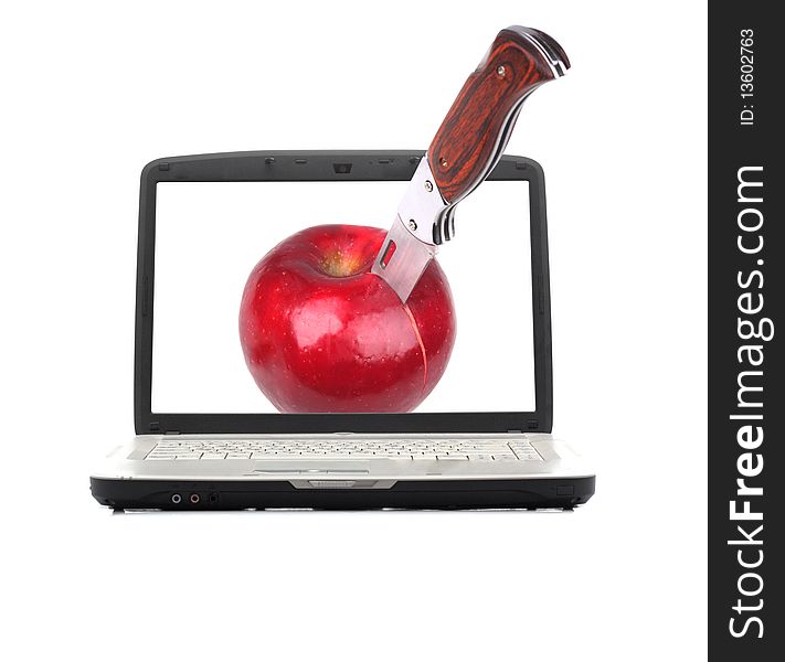 Knife cutting an apple on the screen laptop. Isolated on a white background