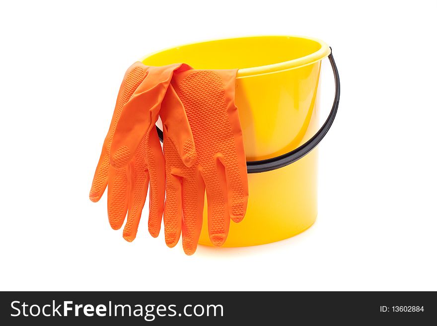 Yellow bucket, gloves on a white background