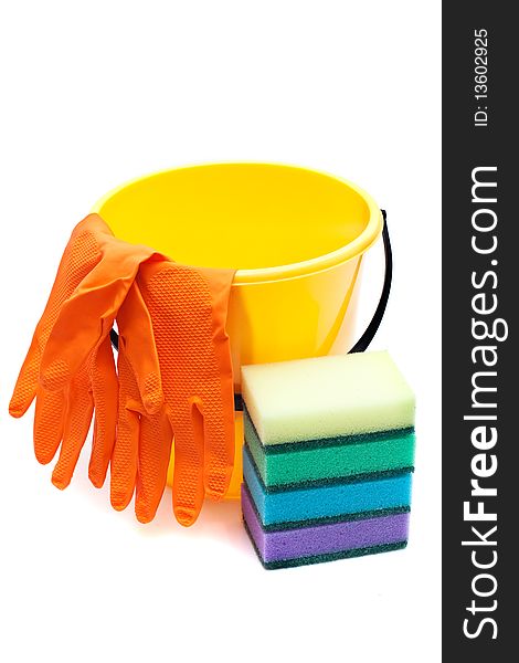 Yellow bucket, gloves and sponges to wash dishes on a white background