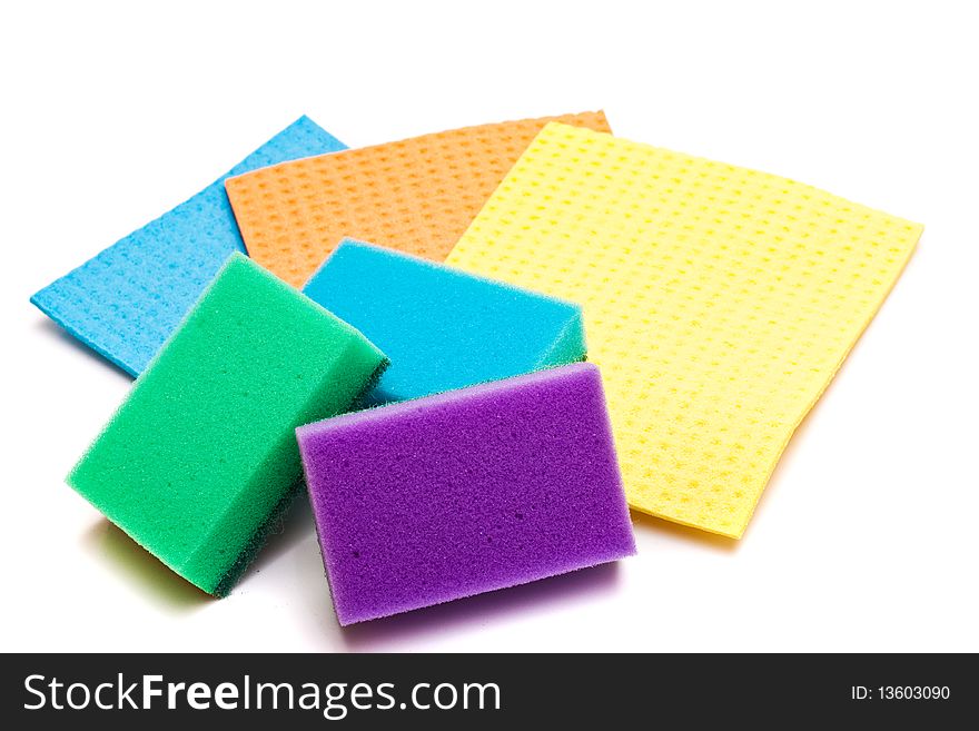 Colored sponges for washing dishes and clothes on a white background