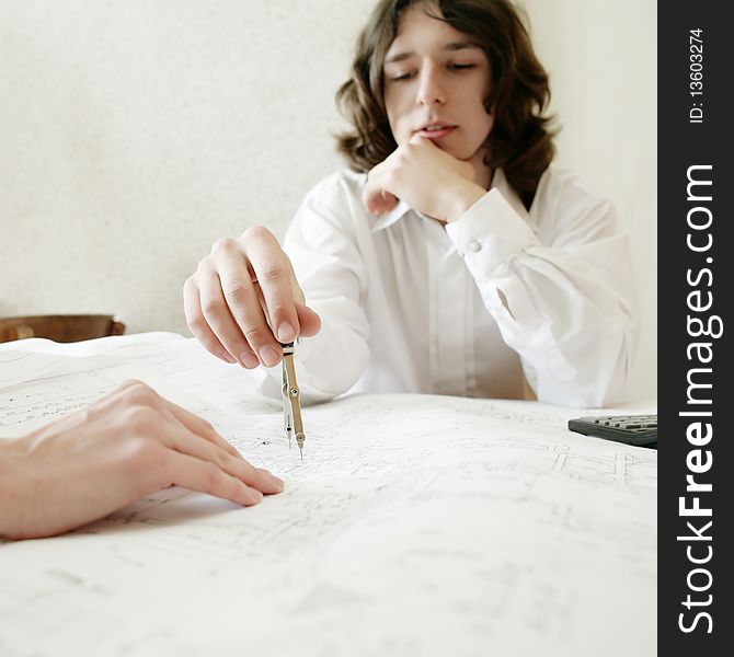 An image of a young architect, focus on a hand