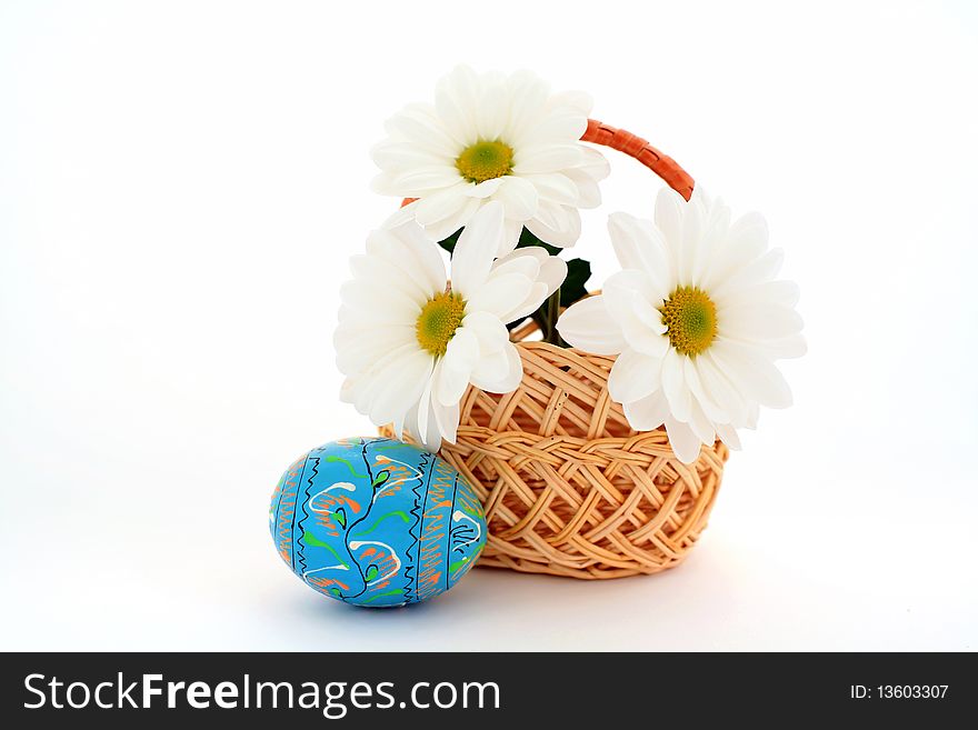 Three flowers in a basket and an egg. Three flowers in a basket and an egg