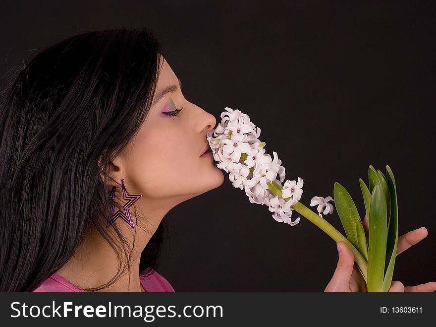 Girl smelling flower. Studio shot. Girl smelling flower. Studio shot.