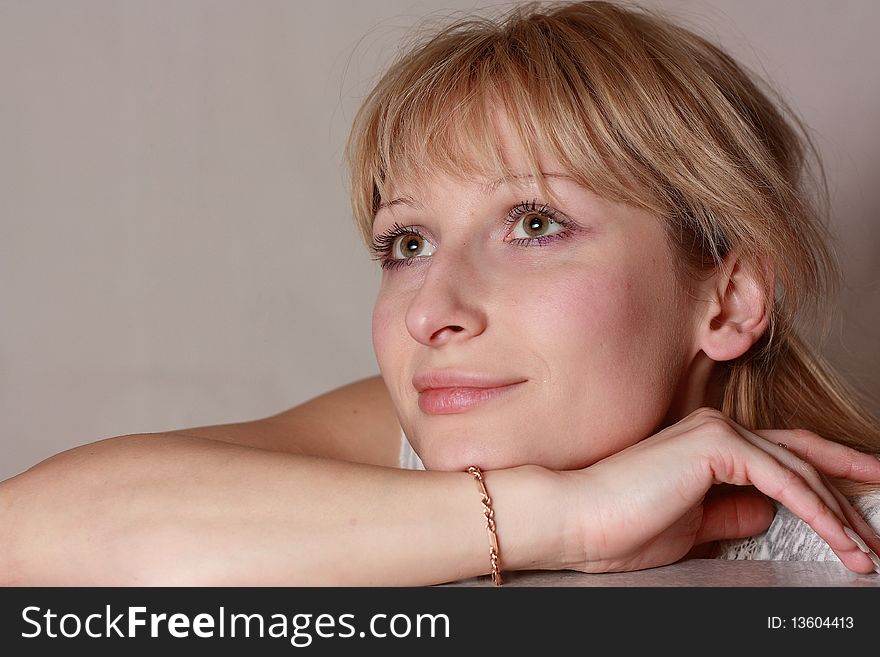 Head shot of smiling woman by grey background