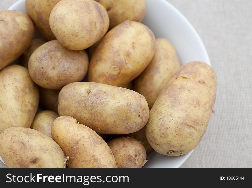 White bowl with fresh potatoes. White bowl with fresh potatoes