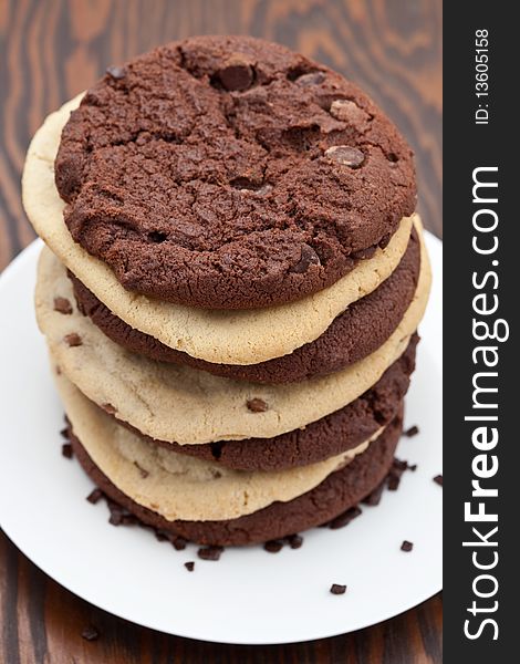 Pile of home baked giant chocolate cookies on a white plate