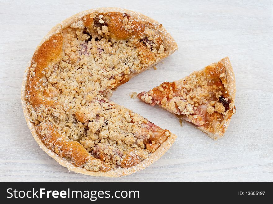 Freshly baked rhubarb crumble on a wooden board