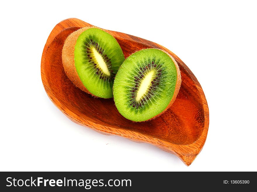 Kiwi fruit on a wooden plate. Isolation  on a white background