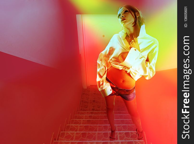 Adult woman standing at stairs with red wall and glaring light. Adult woman standing at stairs with red wall and glaring light