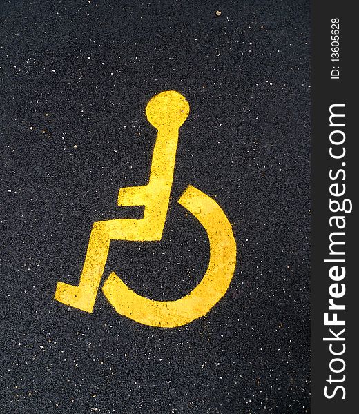 Ã‚Â Asphalt road with yellow disable man logo