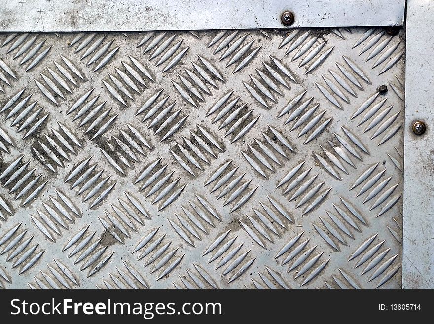 Detail of a grid whith board of steel placed along a road
