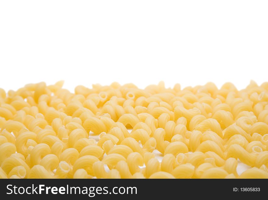 A layer of pasta swirls on a white background. A layer of pasta swirls on a white background
