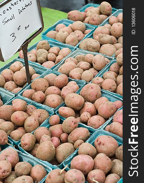 Cartons of red potatoes for sale at a farmer's market. Cartons of red potatoes for sale at a farmer's market.