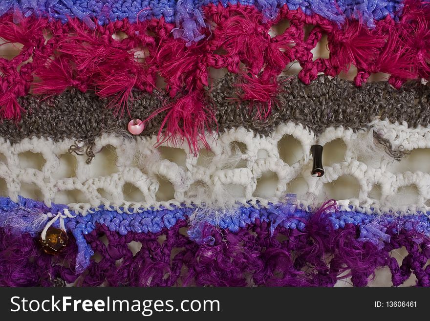 A close-up of a mixed material crochet wall hanging. A close-up of a mixed material crochet wall hanging