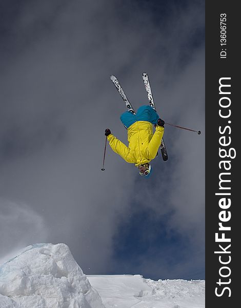 Skier doing a backflip off a backcountry jump. Skier doing a backflip off a backcountry jump.