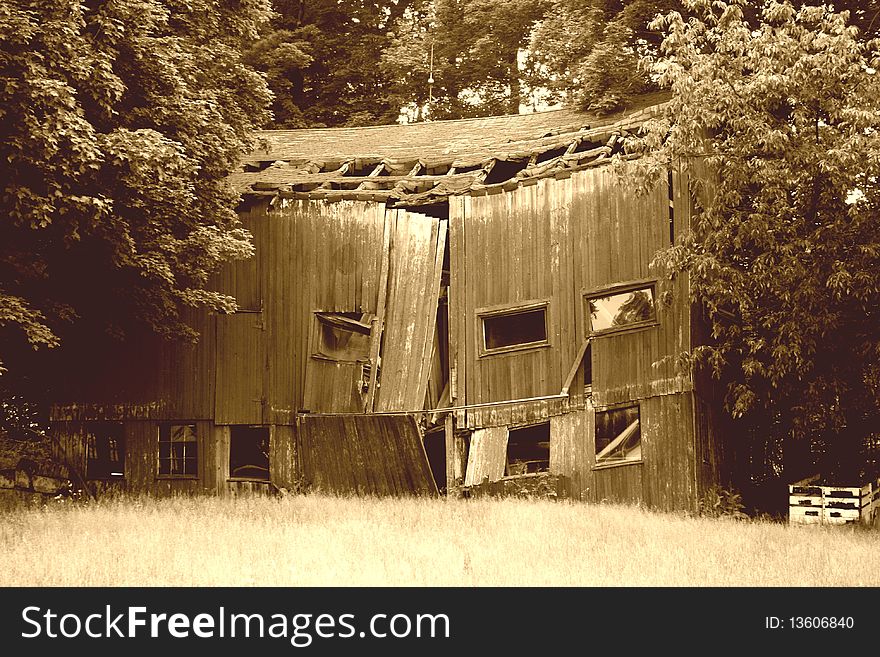 A old barn falling apart in Ohio in sepia. A old barn falling apart in Ohio in sepia