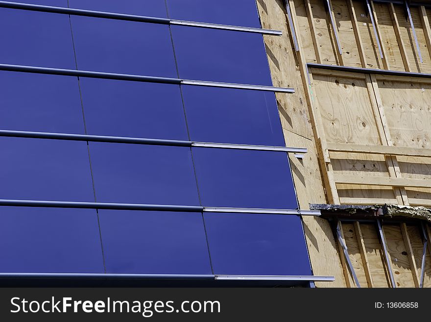 Damaged skyscraper window in process of being repaired. Damaged skyscraper window in process of being repaired