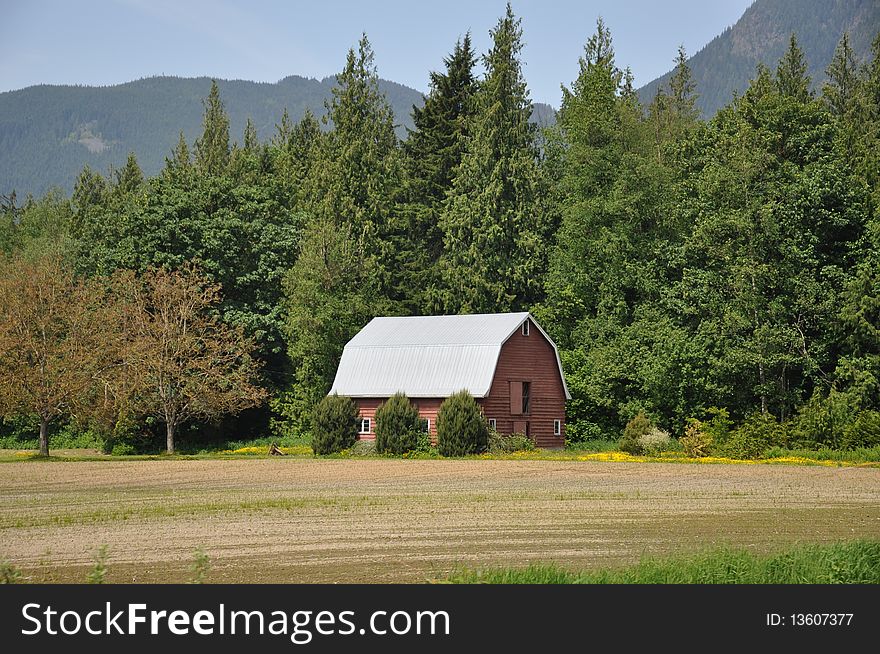 Red Barn situated in a meadow backing on to forest and mountain views in the Mission Valley. Red Barn situated in a meadow backing on to forest and mountain views in the Mission Valley