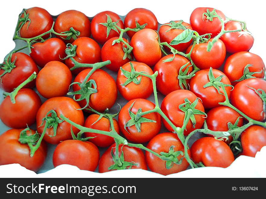 Many deep red tomatoes with green stems, full with antioxidants. Many deep red tomatoes with green stems, full with antioxidants.