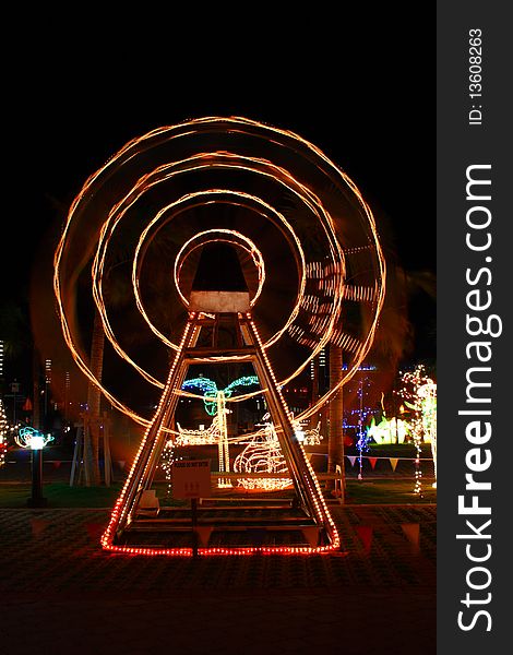 Wheel illuminated at night in funfair park. Wheel illuminated at night in funfair park