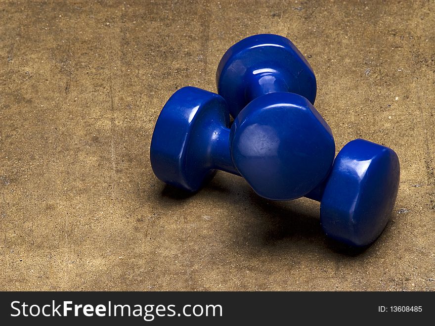 Blue dumbbells on grunge textured background