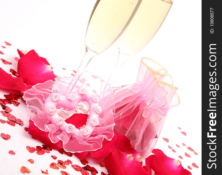 Champagne and petals of roses on a white background. Champagne and petals of roses on a white background