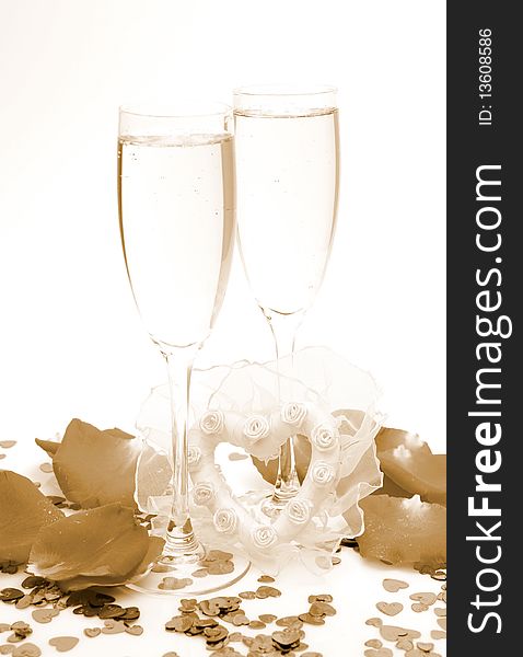 Champagne and petals of roses on a white background. Champagne and petals of roses on a white background