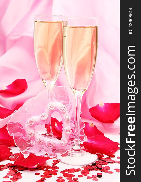 Glasses with a champagne and pink heart. Glasses with a champagne and pink heart