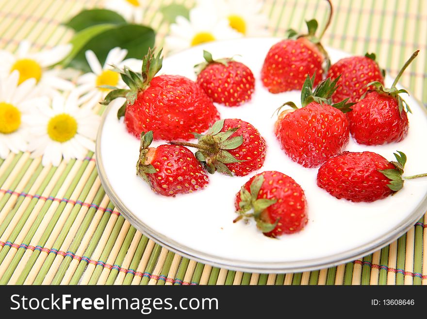 Ripe strawberry in milk on a plate. Ripe strawberry in milk on a plate