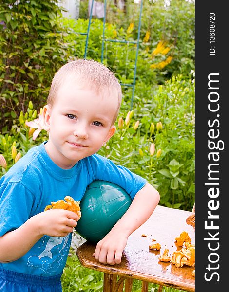 Boy with mushrooms outdoors in the summer