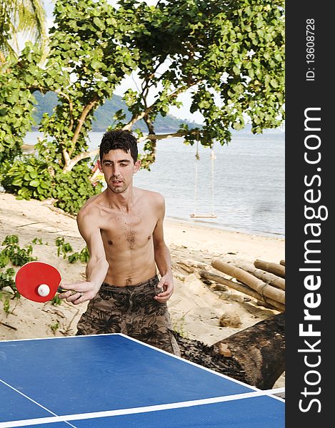 Man playing table tennis on beach. Man playing table tennis on beach